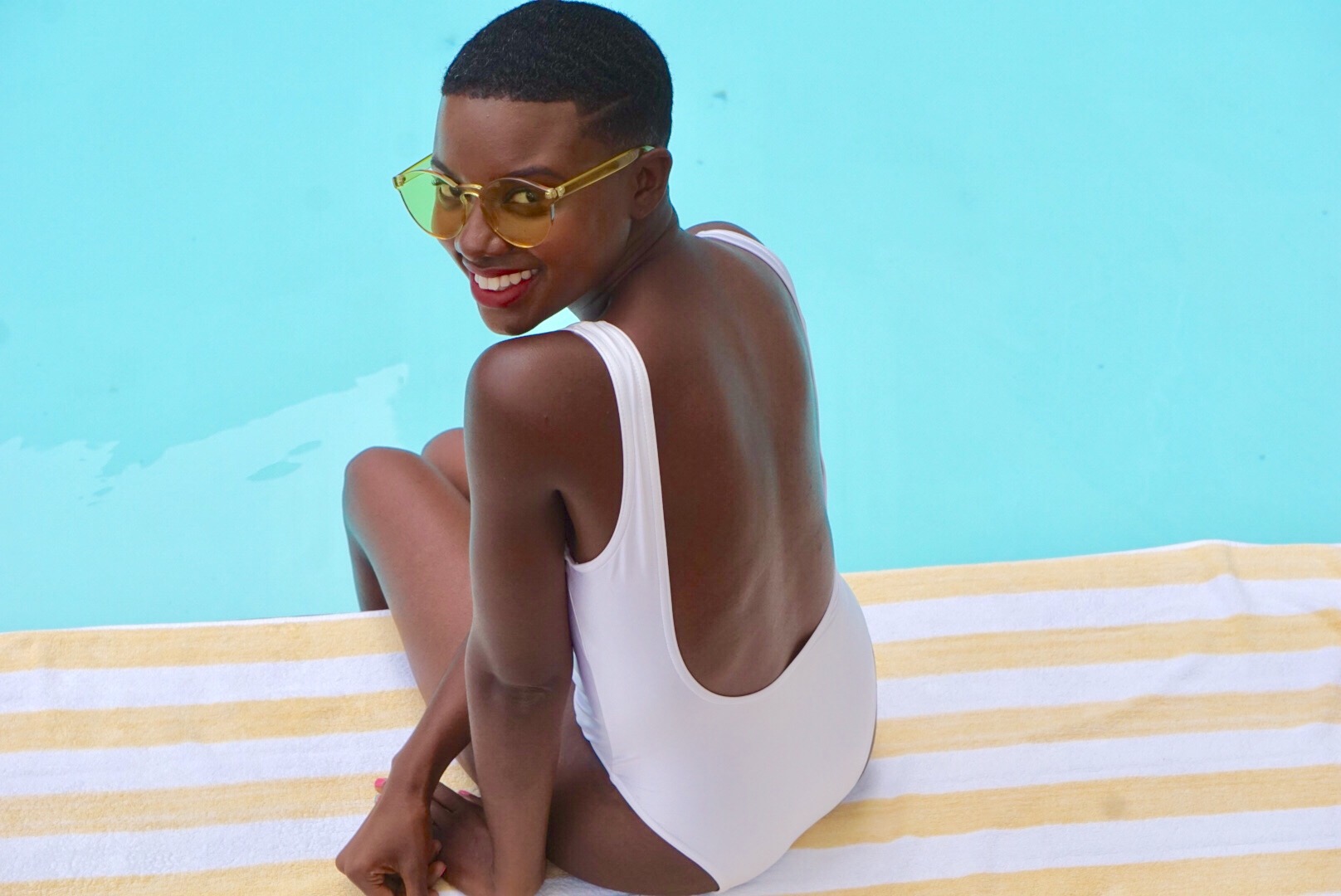 big chop, short natural hair, white one piece swimsuit, acrylic sunglasses